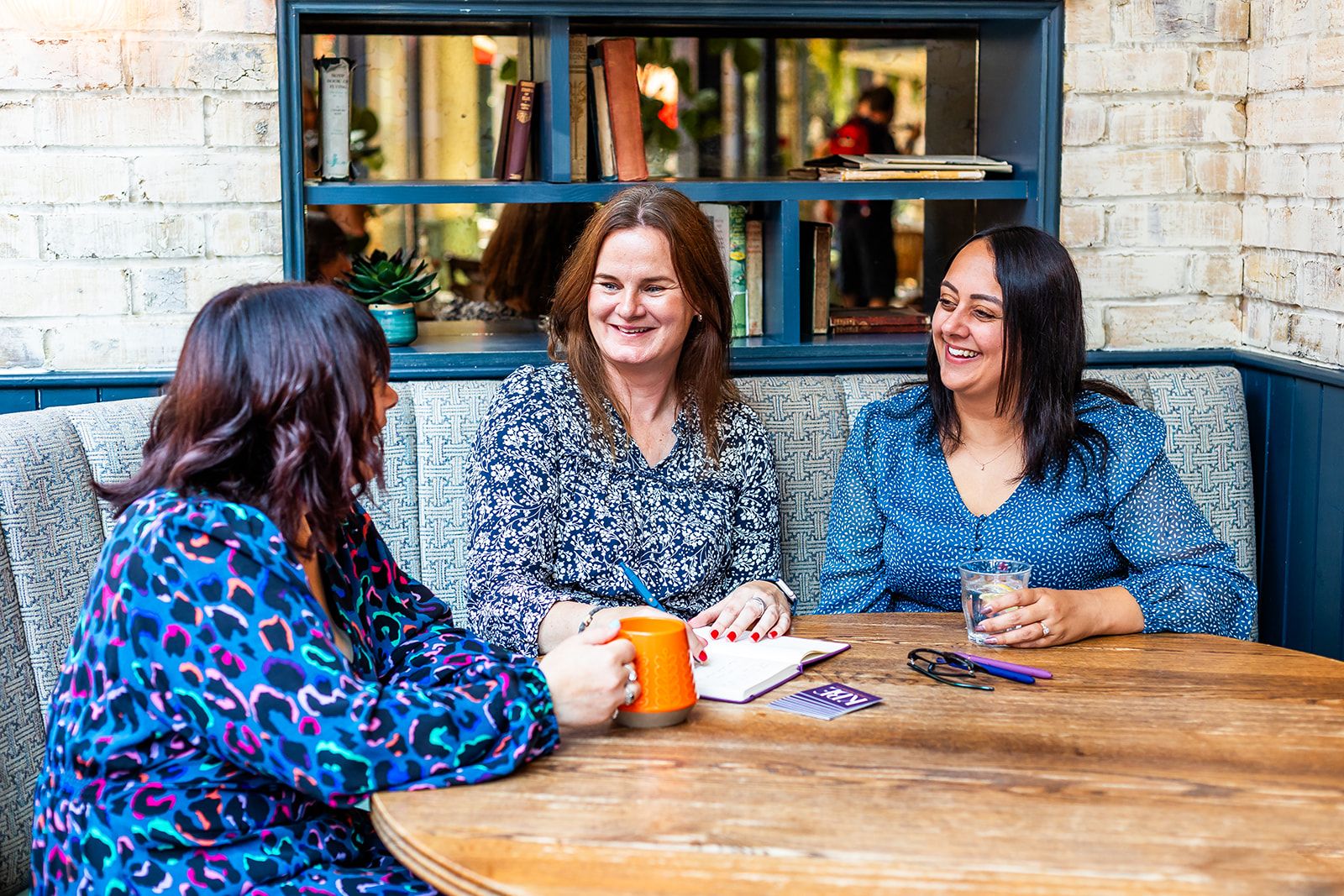 Katie, Emma and Bianca sitting around a large table