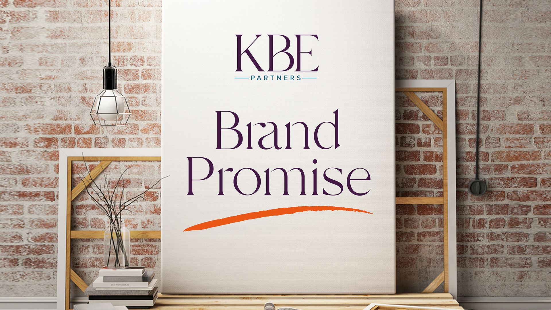 Cream coloured book cover with wording KBE - Brand Promise - standing against a wall